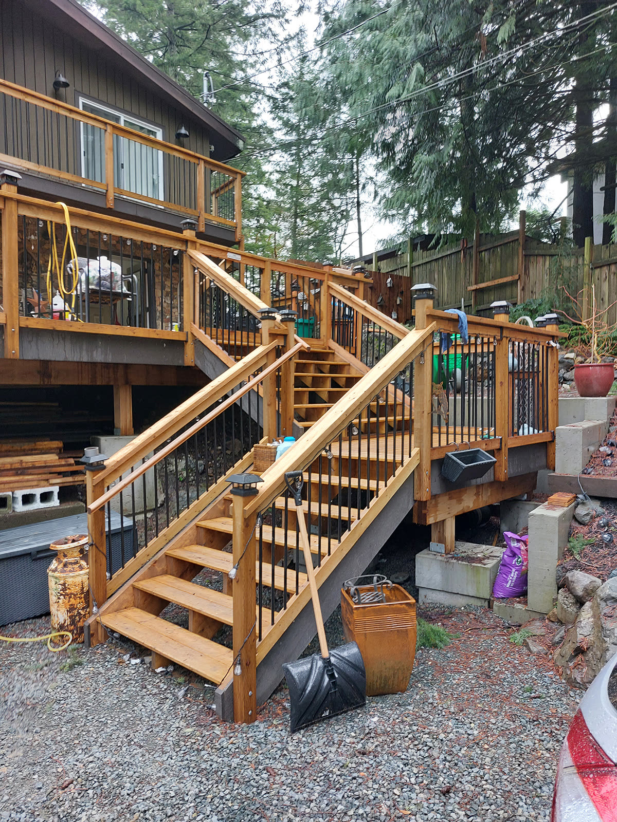 Cedar deck and stairs with black metal balusters